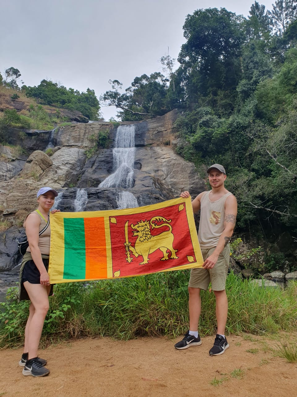 Couple with Sri Lankan flag at waterfall